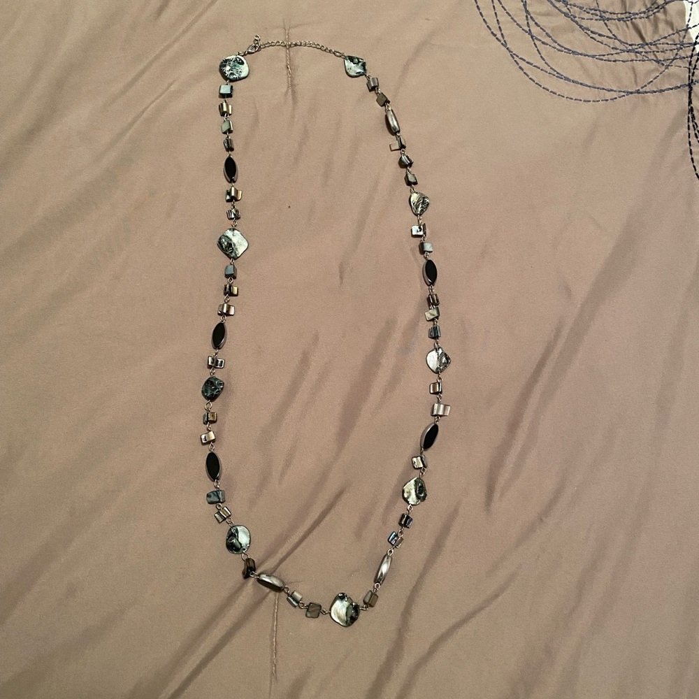 Long necklace with matching earrings.